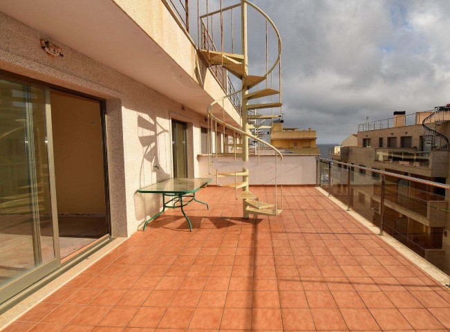 Bright top-floor apartment for sale near the sea in Cala Bona